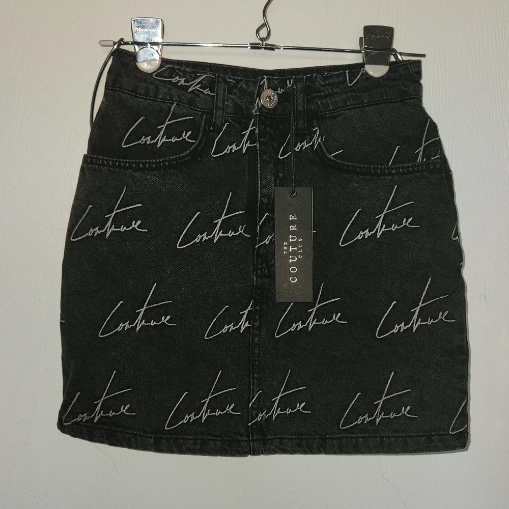 The couture Club Embroidery washed out black Jean Skirt. Size S.